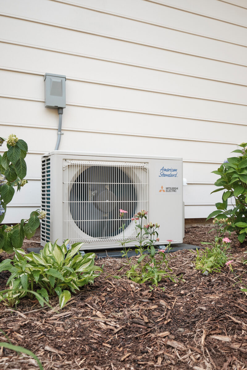 Outdoor ductless air conditioning unit installed beside a home