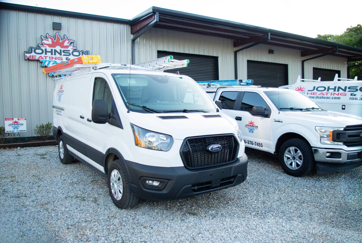 Johnson Heating & Air Conditioning service vans parked outside